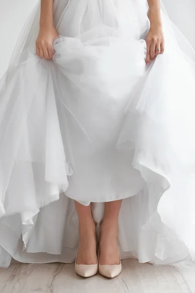 Bride in a beautiful wedding gown and shoes — Stock Photo, Image