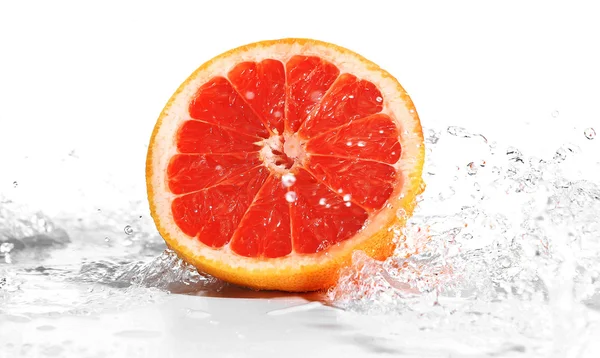 Fresh grapefruit in splashing water isolated on white — Stock Photo, Image