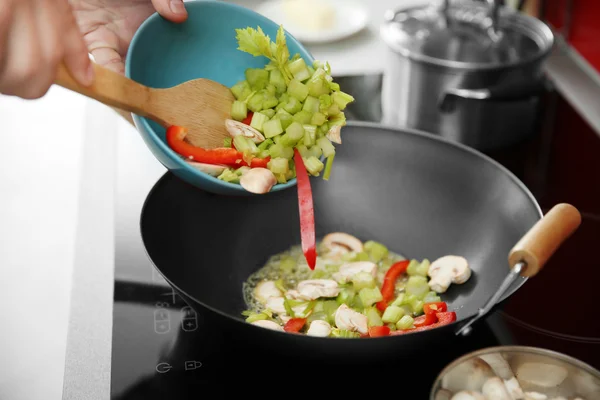Female hands putting vegetables — Stock Photo, Image