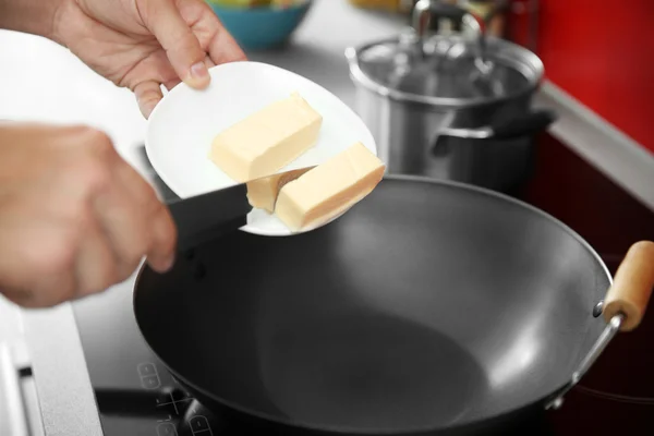 Female hand putting butter — Stock Photo, Image