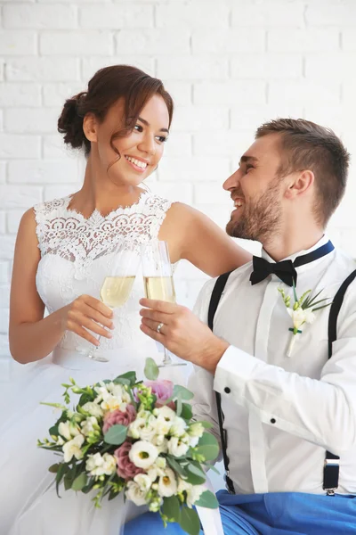 Groom and bride with glasses of champagne — Stock Photo, Image