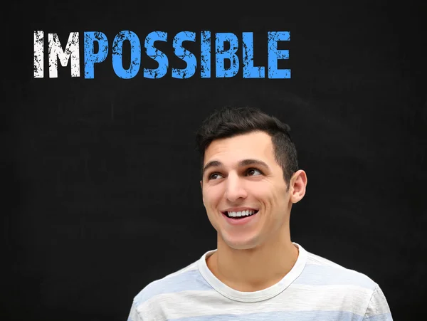 Young Man Blackboard Word Impossible Transformed Possible — Stock Photo, Image