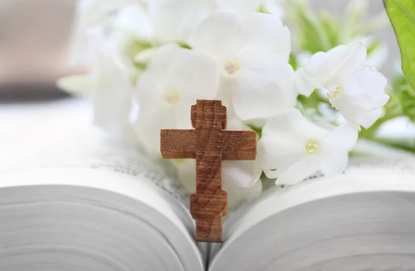 Houten kruis met bloemen en Bijbel — Stockfoto