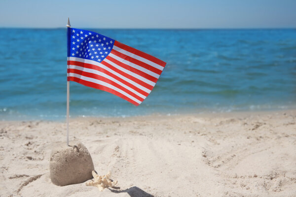 American flag with sand castle 
