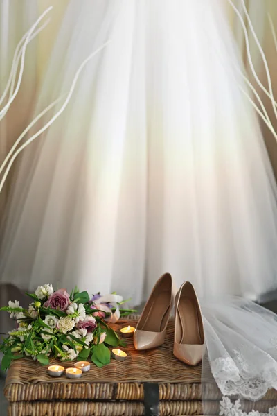 Shoes on wicker chest and wedding dress — Stock Photo, Image