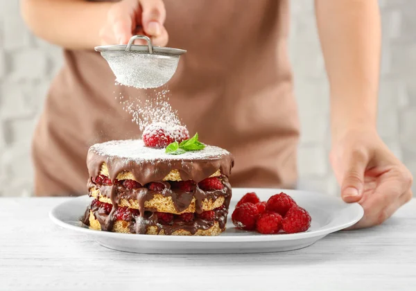 Woman powdering berry cake — Stock Photo, Image