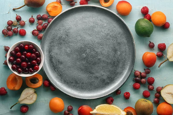 Different fruits with plate — Stock Photo, Image