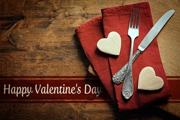 Fork with knife and wooden hearts — Stock Photo, Image