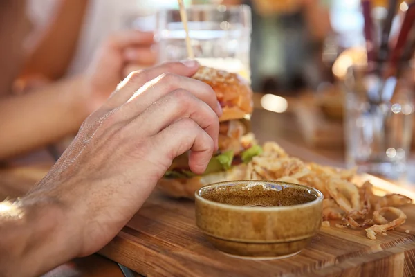 Man drinking beer and  snacks