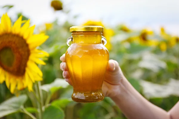 Woman holding bottle of honey