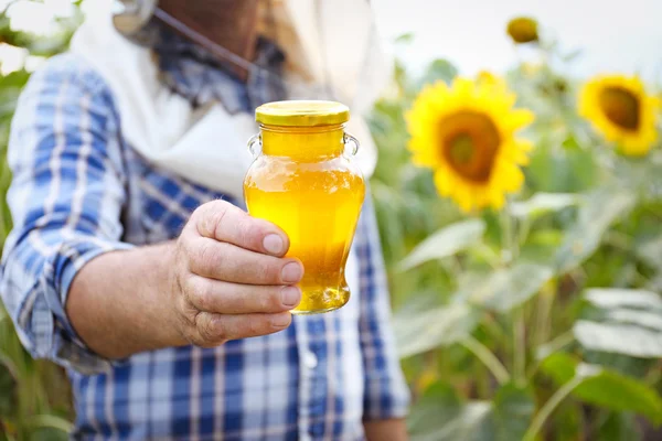Man holding bottle of honey