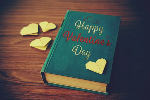 Book and origami hearts — Stock Photo, Image