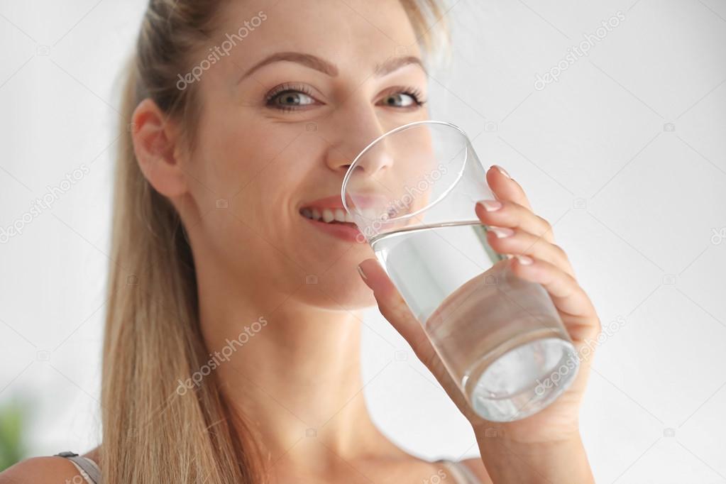 Beautiful girl drinking water 