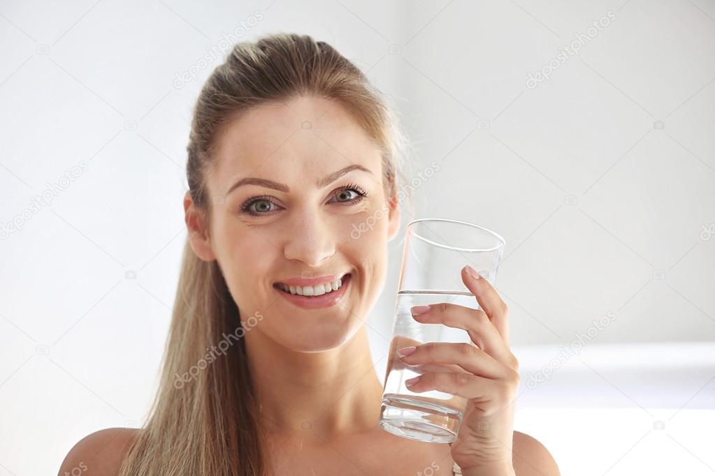 Beautiful girl drinking water 