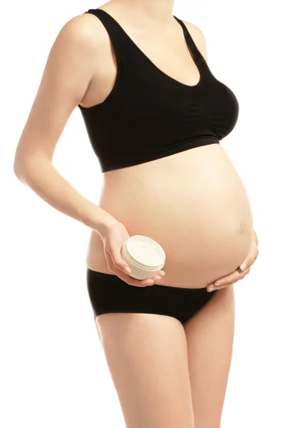 Donna incinta con crema — Foto Stock