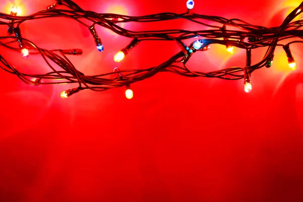 Christmas lights on red — Stock Photo, Image