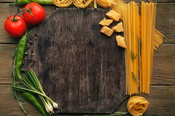 Pasta with vegetables on cutting board — Stock Photo, Image