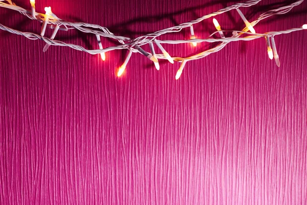 Kerstverlichting op roze — Stockfoto
