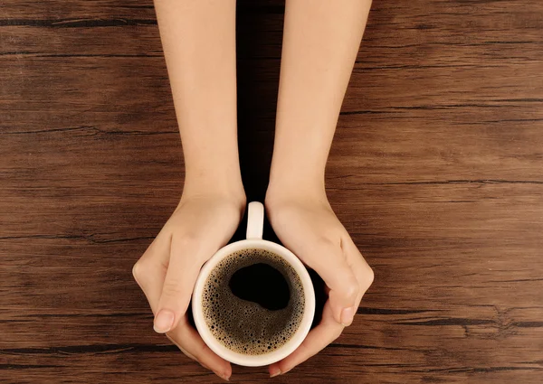 Woman holding cup of coffee — Stock Photo, Image