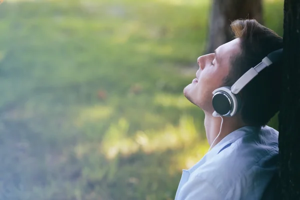 man listening music in park