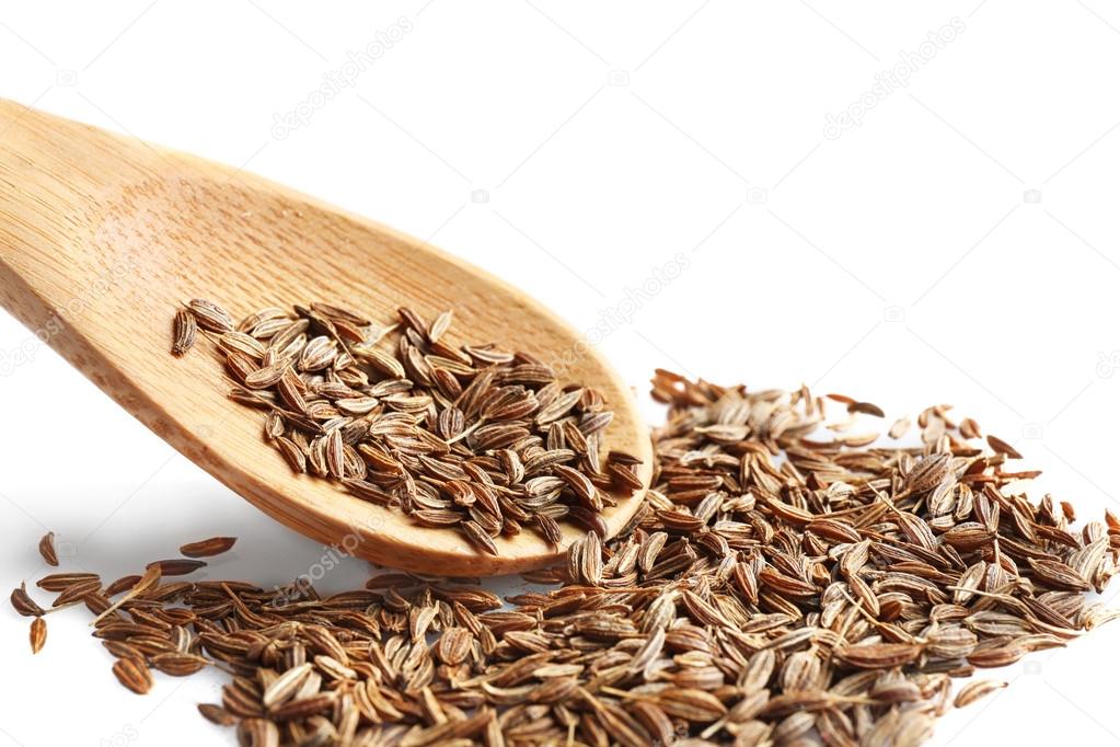 Cumin seeds and wooden spoon