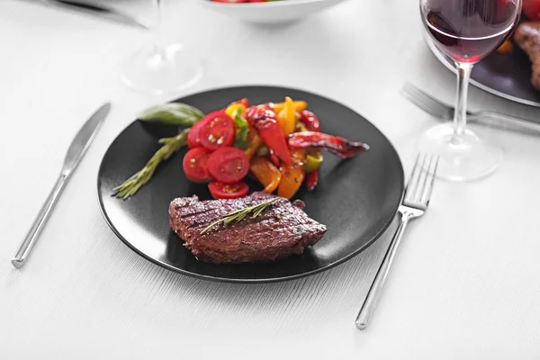 Sabroso bistec con verduras fritas en la mesa — Foto de Stock