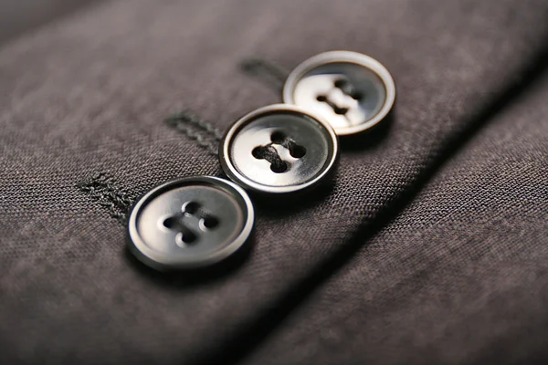 Кнопки на черной одежде — стоковое фото