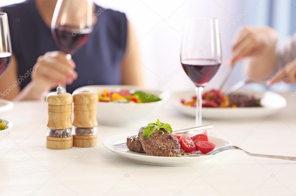 Tasty steak with fresh tomatoes on table