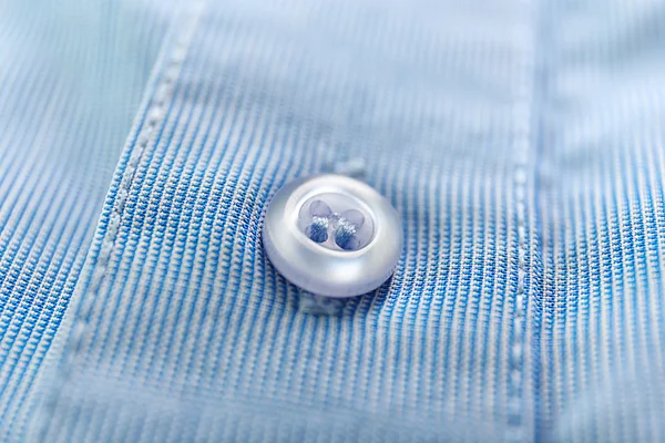 Button on blue clothes — Stock Photo, Image