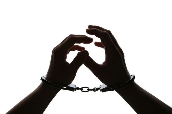 Black silhouette of man hands in handcuffs — Stock Photo, Image