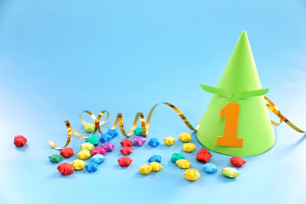 Holiday hat and decor on blue background — Stock Photo, Image