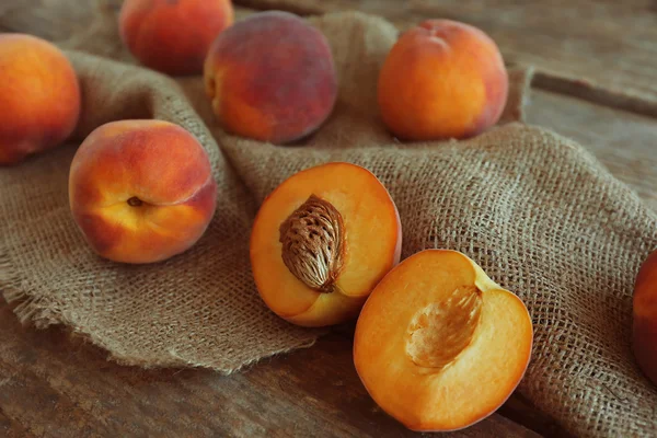 Свіжі персики на мішковині — стокове фото