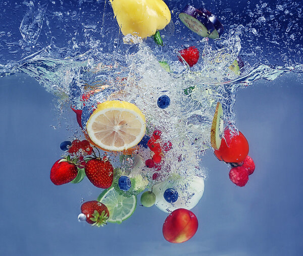 Vegetables and fruits falling into water 