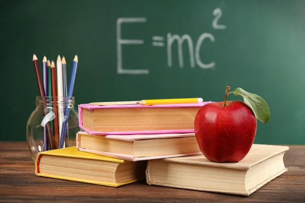 Apple with books and accessories — Stock Photo, Image