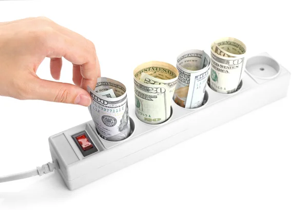 Hand putting dollars into power socket — Stock Photo, Image