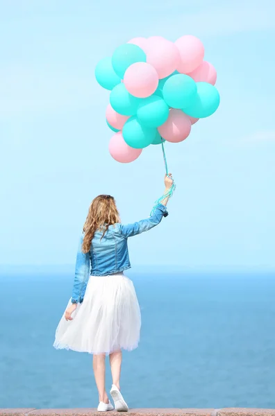 Woman with colorful balloons — Stock Photo, Image