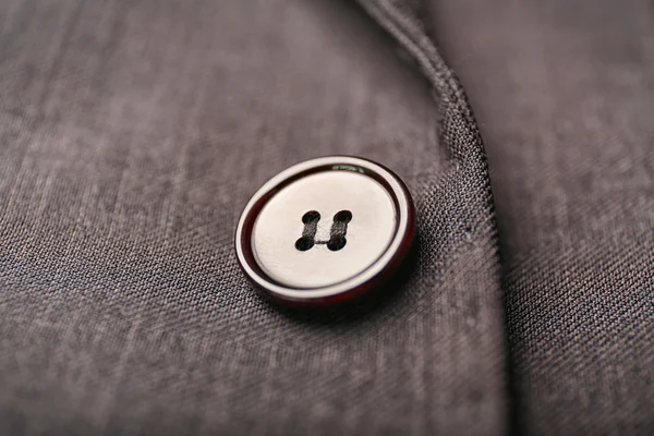 Button on grey clothes — Stock Photo, Image