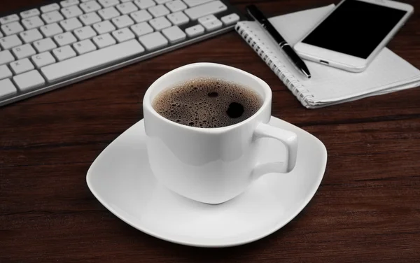 Cup of coffee on modern workplace — Stock Photo, Image