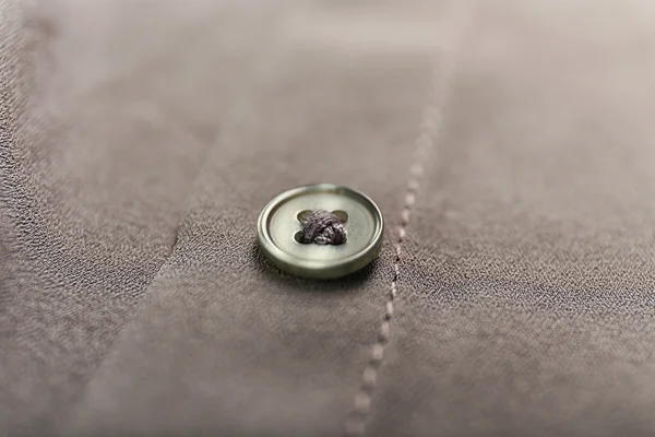 Grey button on clothes — Stock Photo, Image