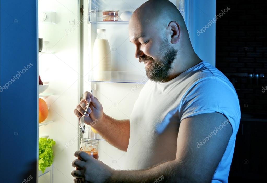 Man Eating Night Next Refrigerator — Stock Photo © belchonock 122788784