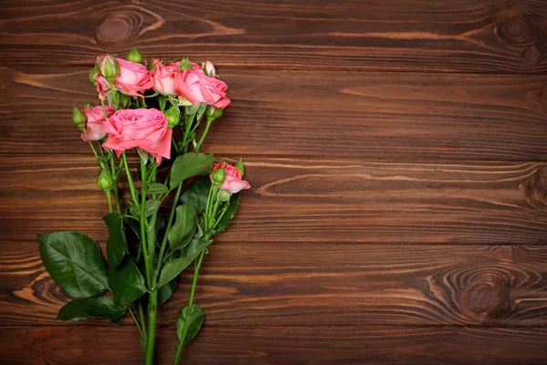 Fresh flowers on  wooden background — Stock Photo, Image