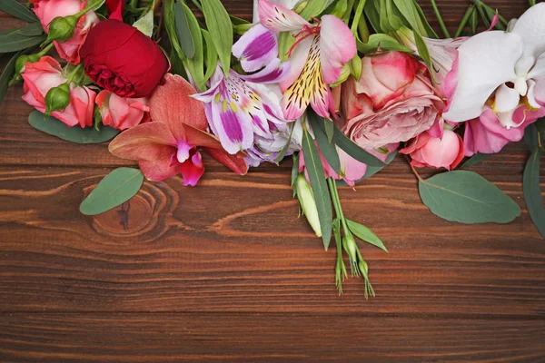 Fresh flowers on  wooden background — Stock Photo, Image