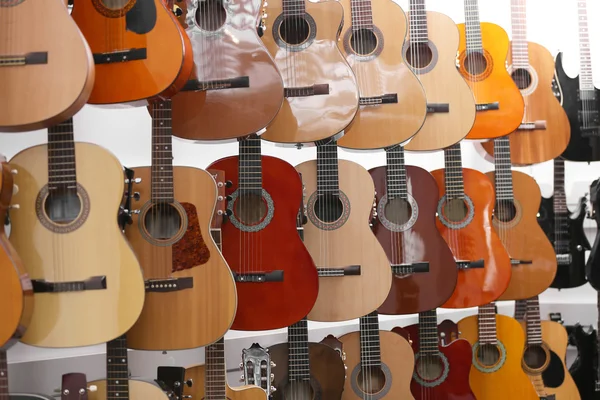 Guitars hanging on wall, closeup — Stock Photo, Image