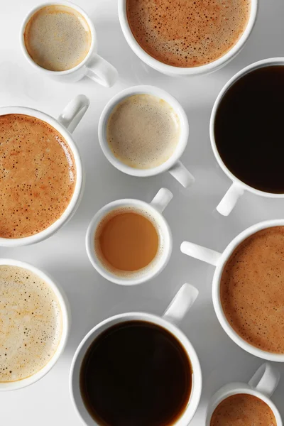 Cups of coffee on white background, top view — Stock Photo, Image