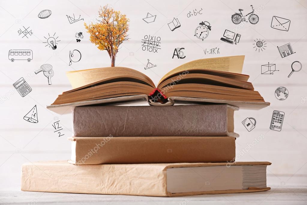 Stack of books with tree Stock Photo by ©belchonock 123143600