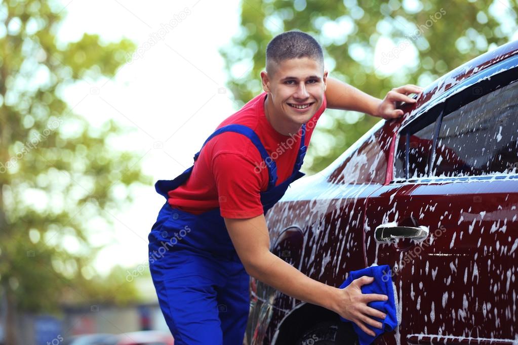 Serviceman washing car