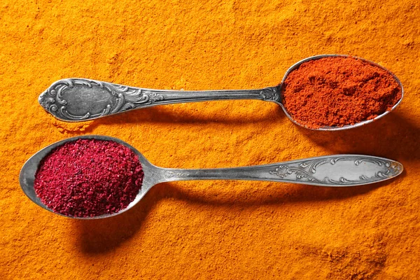 Spoons with spices on color background — Stock Photo, Image