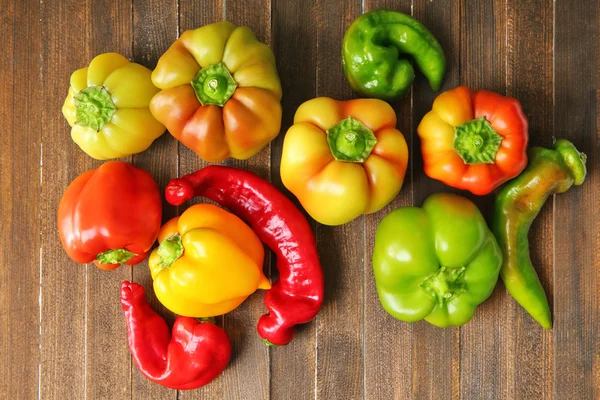 Fresh peppers on wooden table — Stock Photo, Image