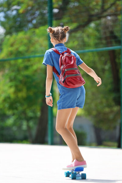 young girl riding skateboard