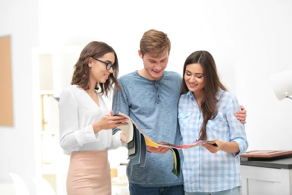 stock image couple talking with designer